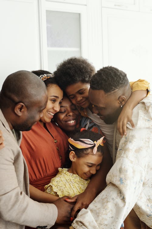 Happy black family smiling - Win Realty